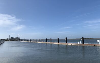 Fernandina Beach Wave Attenuator or Breakwater Driving Epoxy Coated Round Steel Pipe Pile using barge and crane